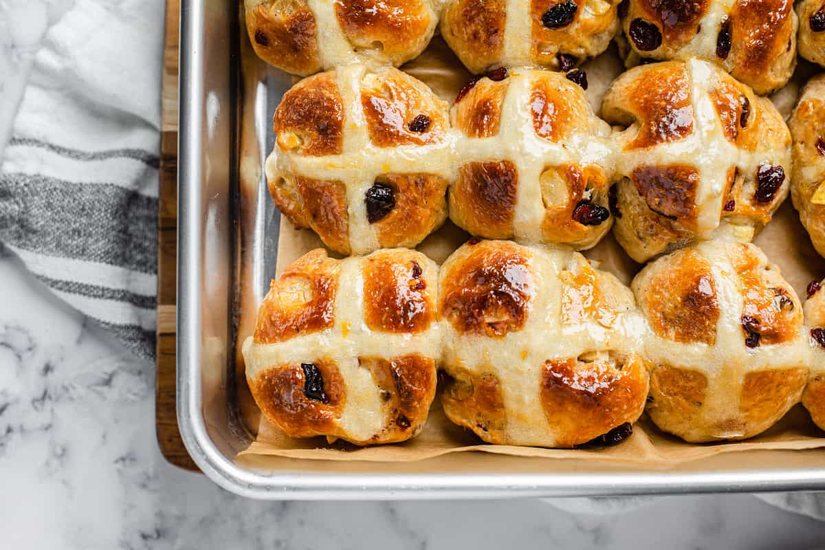 overhead shot of buns with baked-on crosses still in the pan