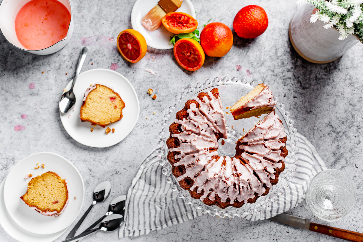 overhead view of table arrangement with blood orange pound cake and cake slices on plates