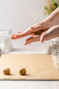 hands rolling dough into balls