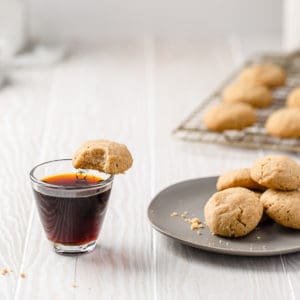 Swedish dream cookies on a plate and one balanced on an espresso cup
