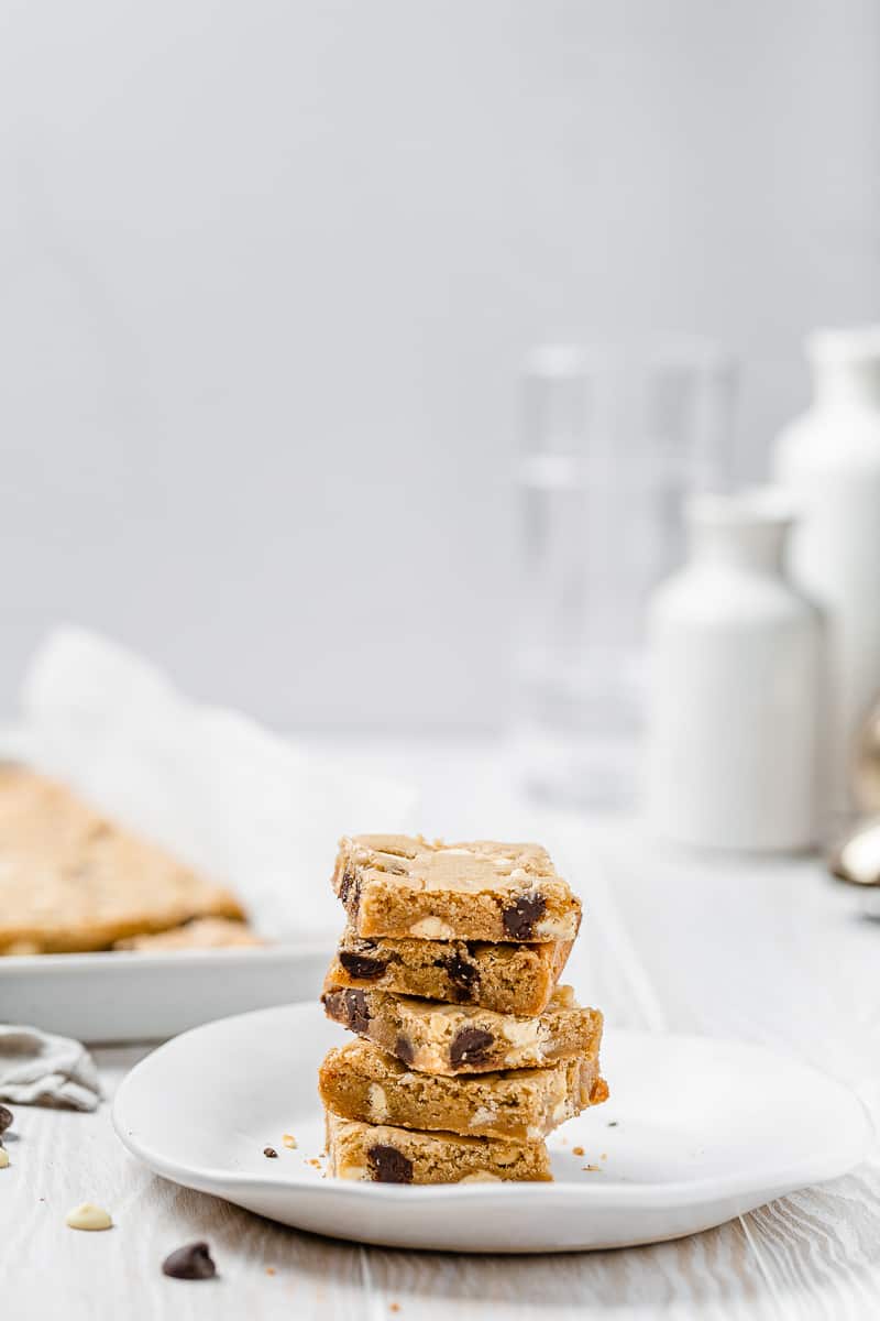 stack of blondies on a plate with baking tray
