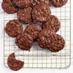 overhead shot of chocolate toffee cookies piled up on a cooling rack
