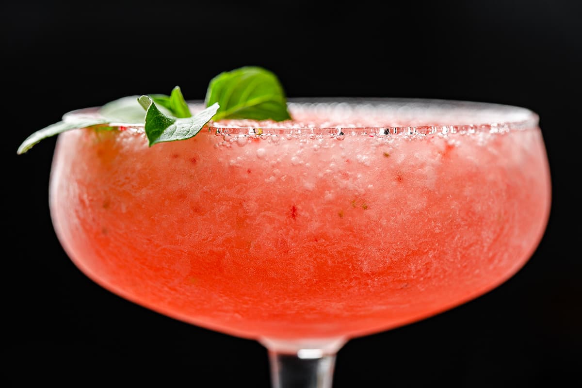 side view closeup of frozen strawberry cocktail in a coupe glass