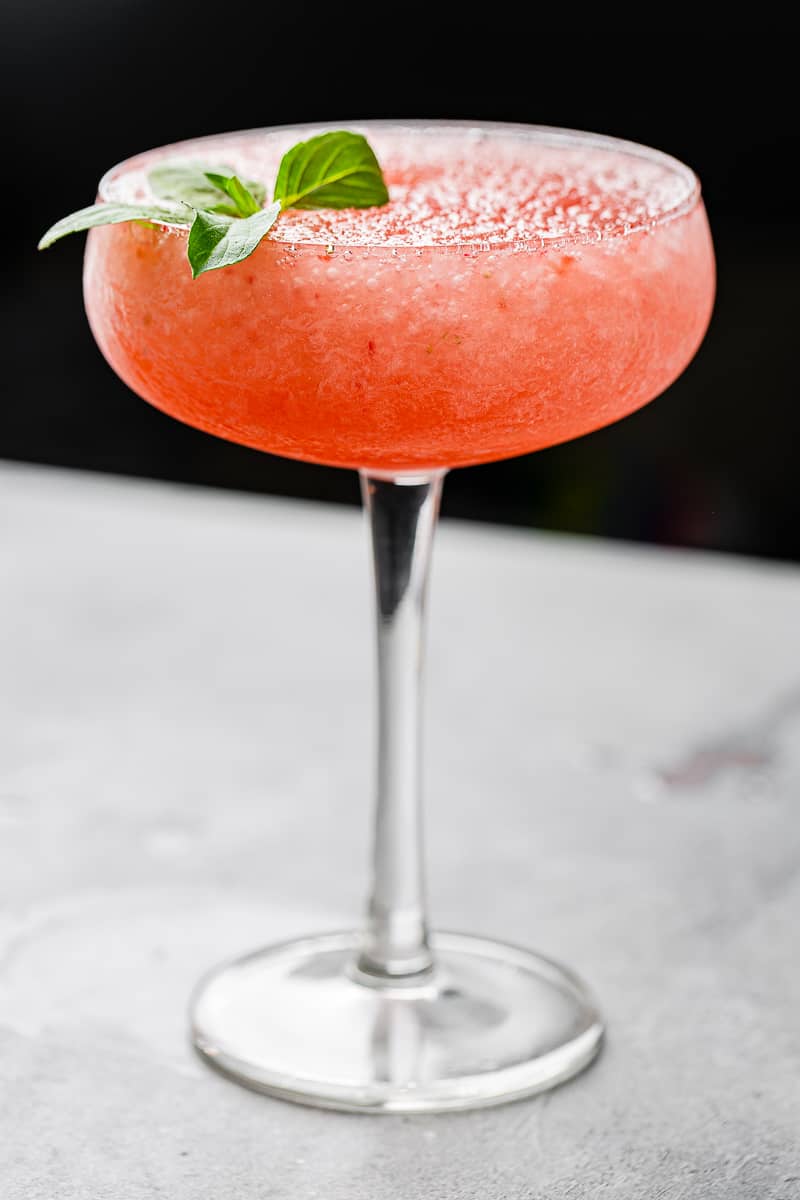 side view of backlit frozen strawberry cocktail