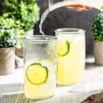 limeade splashing out of a carafe into serving glass