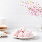Pile of pink snowball cookies on a plate