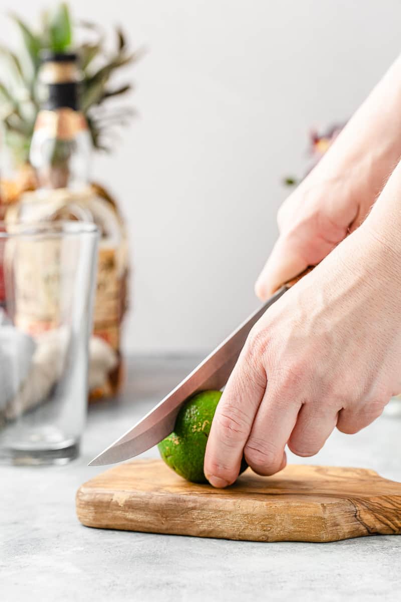 hands cutting a lime