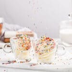 loads of nonpareil sprinkles on buttercream swirls in cups