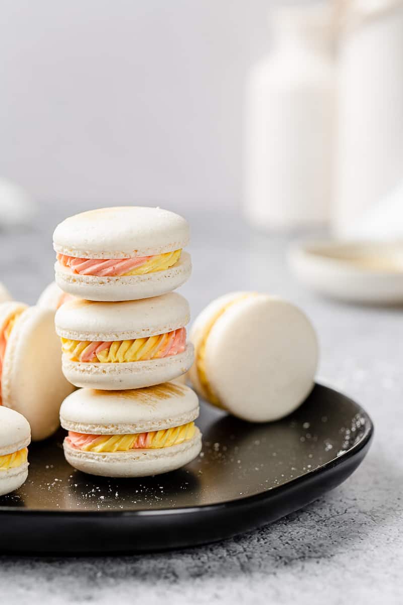 stack of macarons on a black plate