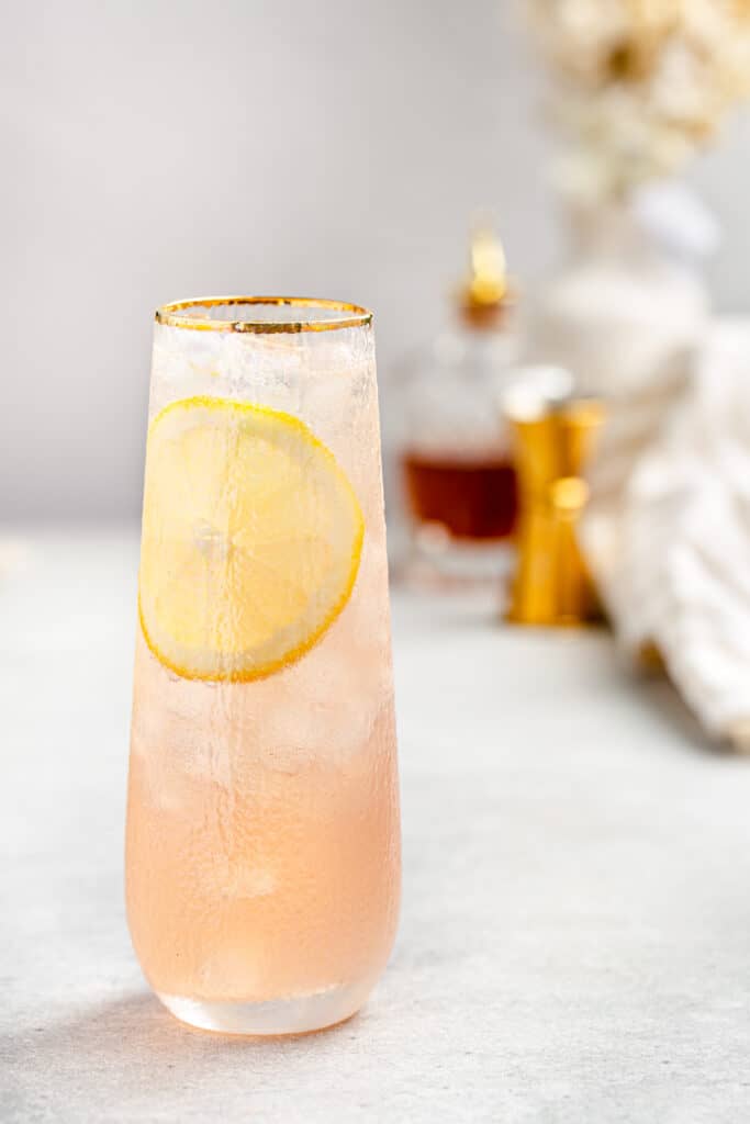 close up of lillet gin cocktail with lemon slice 