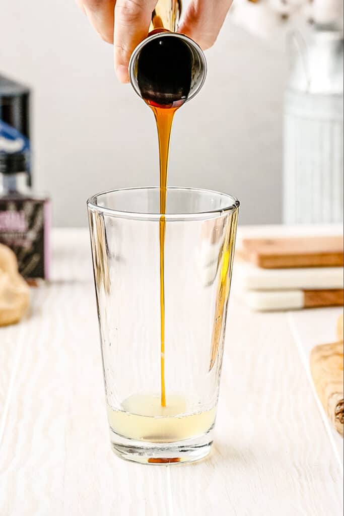 adding honey to cocktail