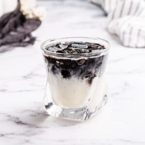 black and white rum cocktail on a marble countertop