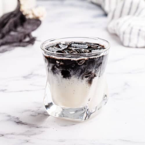 black and white rum cocktail on a marble countertop