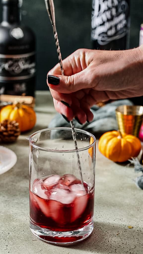stirring cocktail with ice