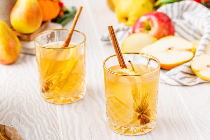 two glasses with fall sangria using white wine, pears and apples