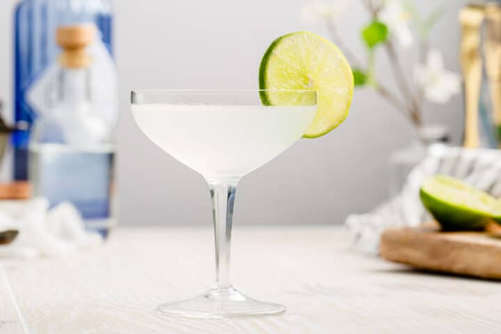 side view of gimlet cocktail with a lime garnish
