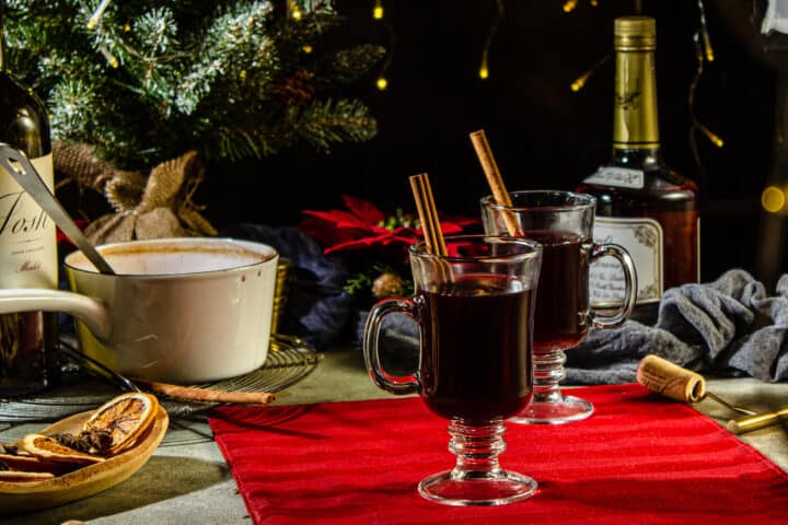 mulled wine on a tabletop with a pot and brandy