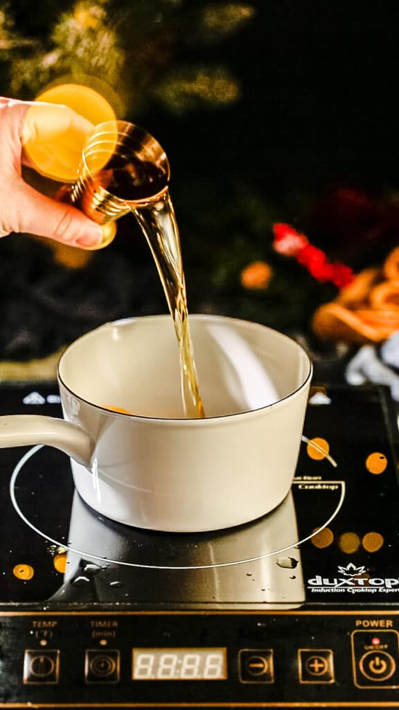 pouring brandy into a pot