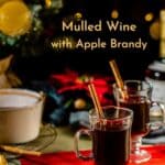 mulled wine on a tabletop with twinkling Christmas lights and tree