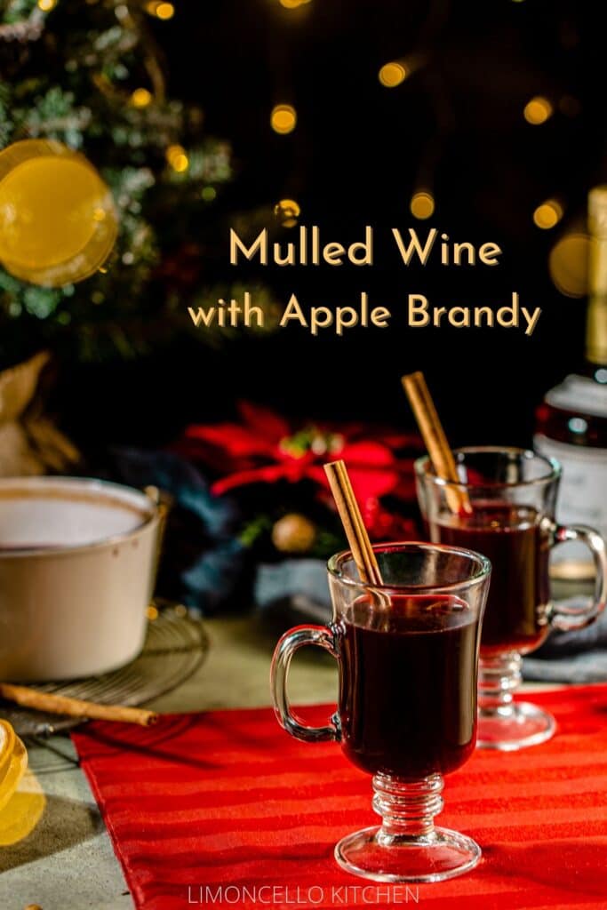 mulled wine on a tabletop with twinkling Christmas lights and tree