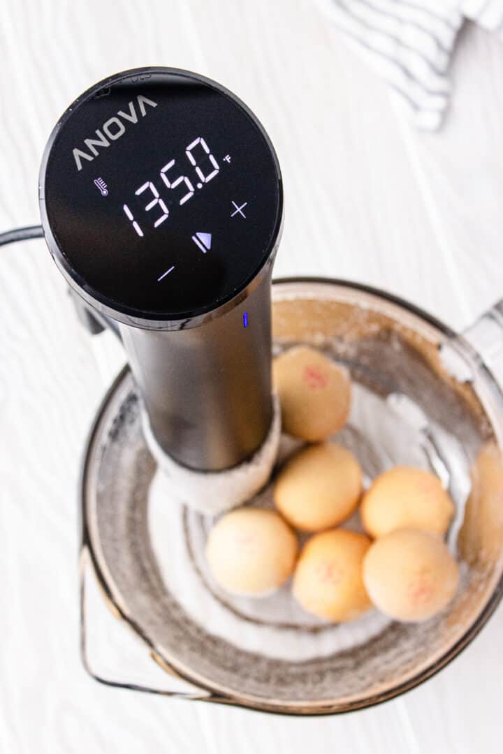 close up of anova sous vide cooker at 135 degree setting