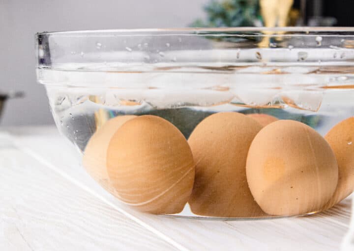 close up of brown eggs in an ice bath