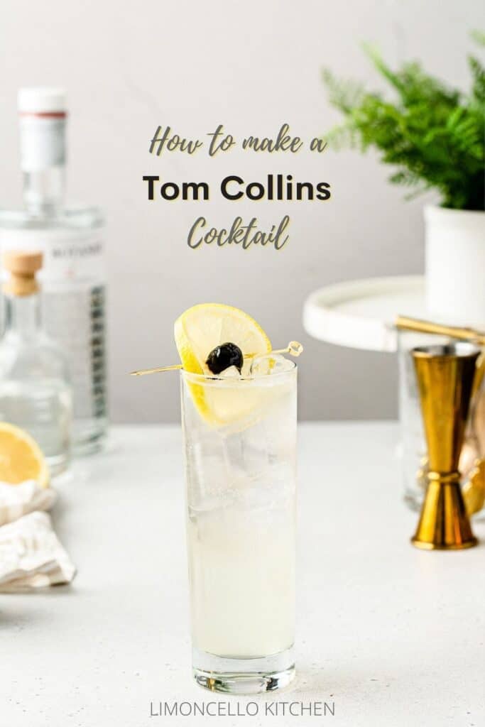 side view of tom collins cocktail with gin, jigger and lemon in the background