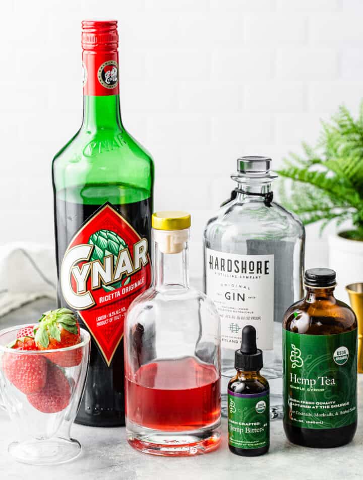 Ingredients for the Strawberry Tequila cocktail on a tabletop together.