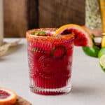 Spicy Blood Orange margarita with jalapenos and a blood orange slice as garnish.