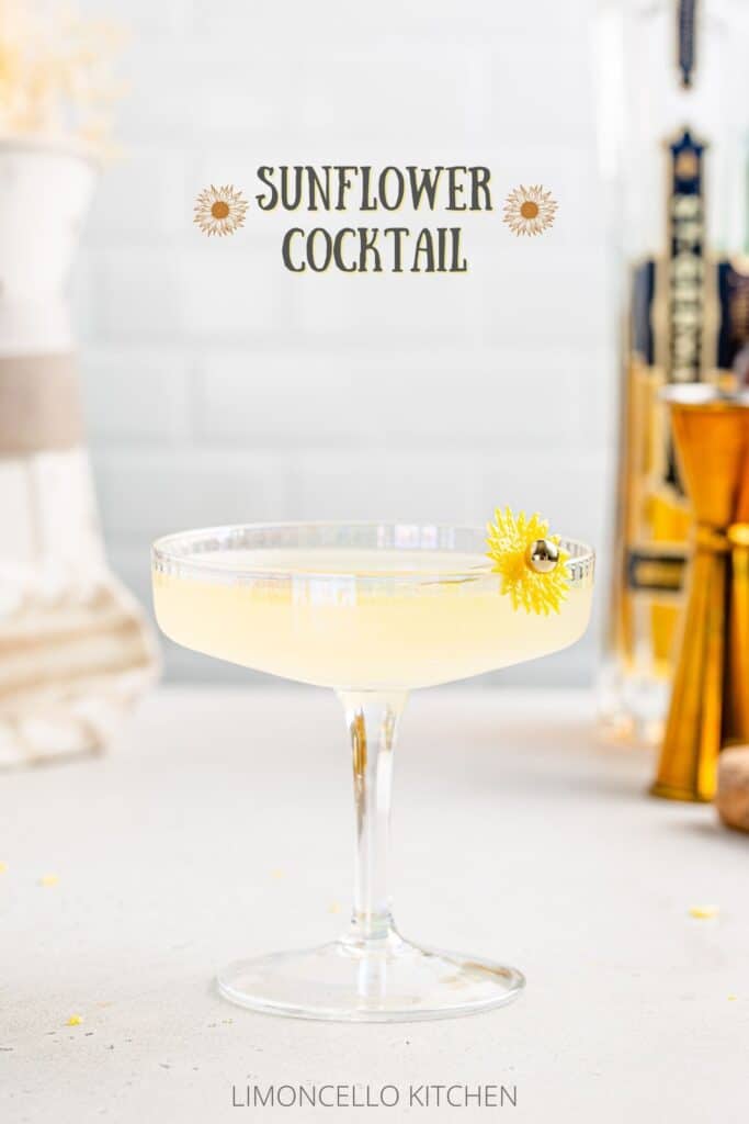Side view of the Sunflower cocktail in a coupe glass with ingredients and tools in the background, and the text SUnflower Cocktail on top.