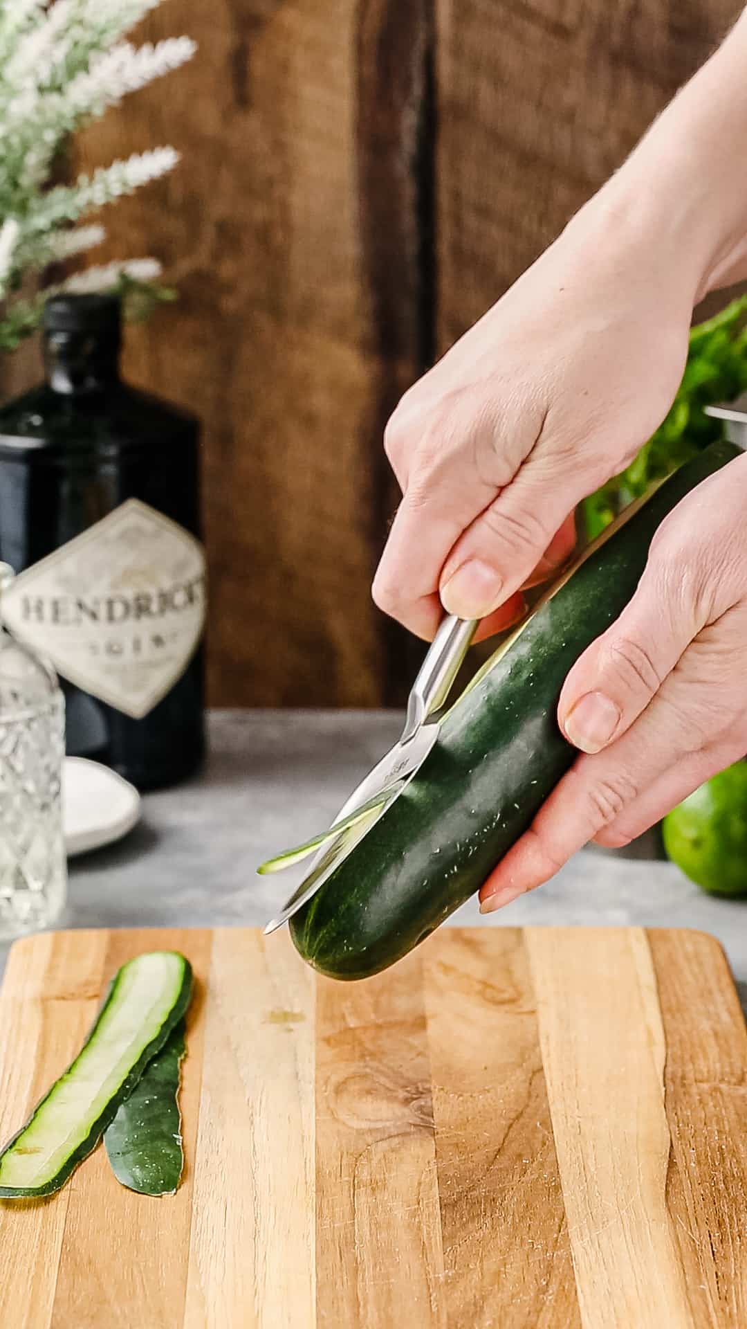 Peeling a cucumber into strips.