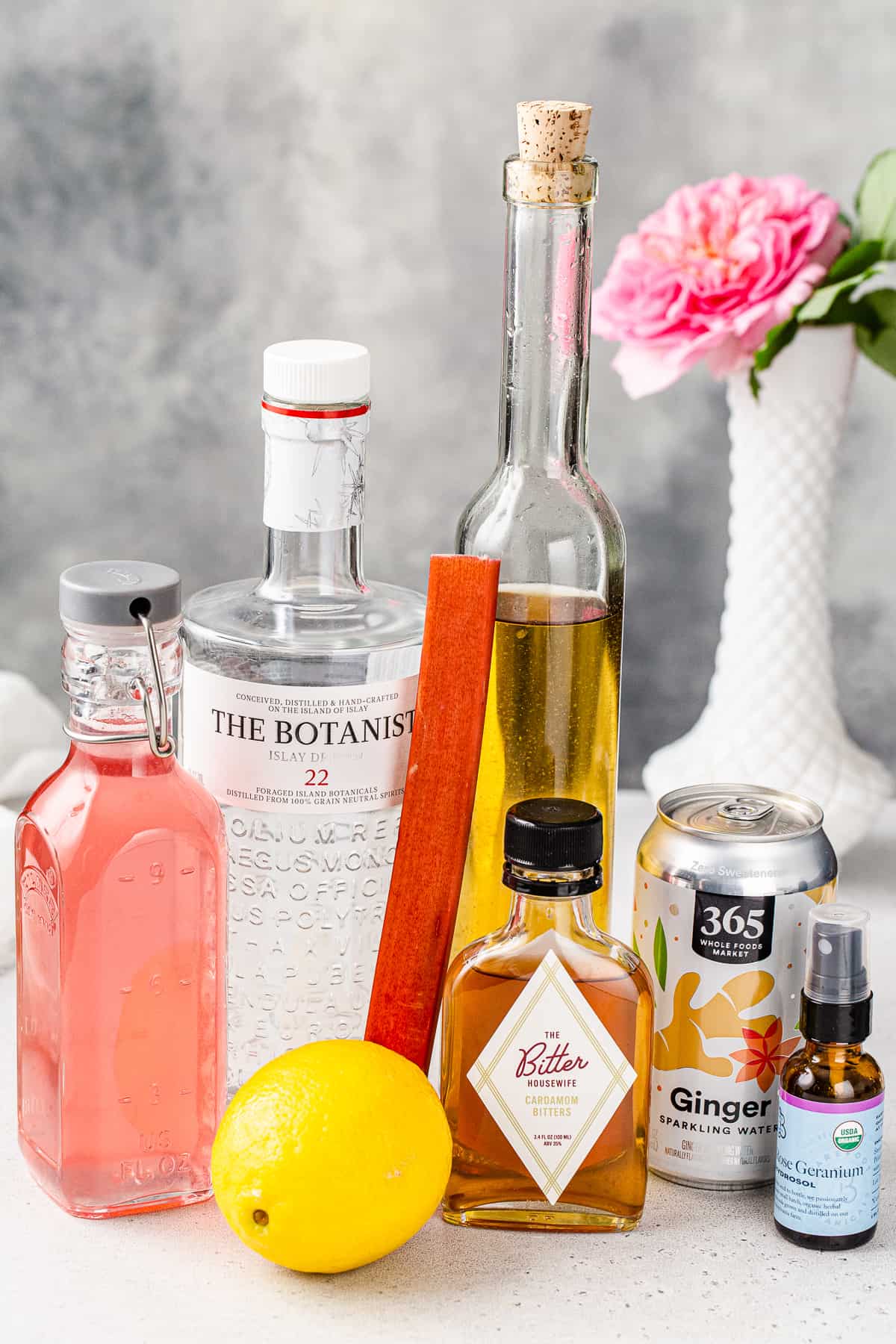 Ingredients to make the Rhubarb Gin Cocktail together on a countertop.