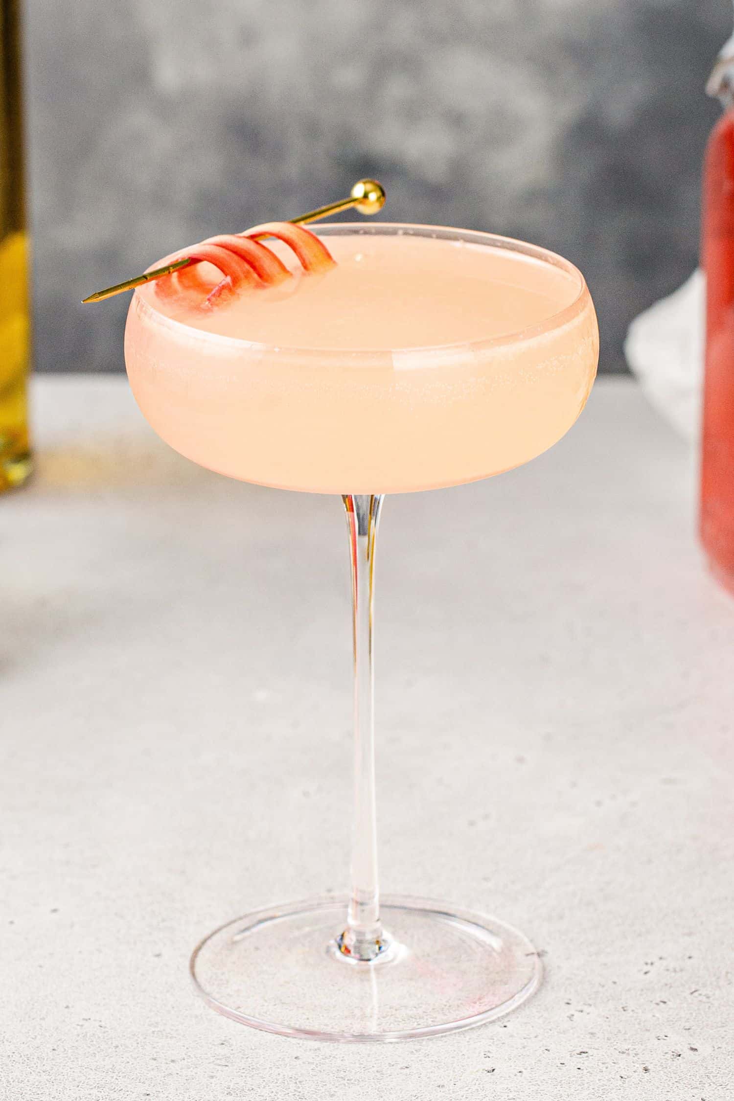 Close up of Rhubarb Gin cocktail in a tall stemmed cocktail glass.