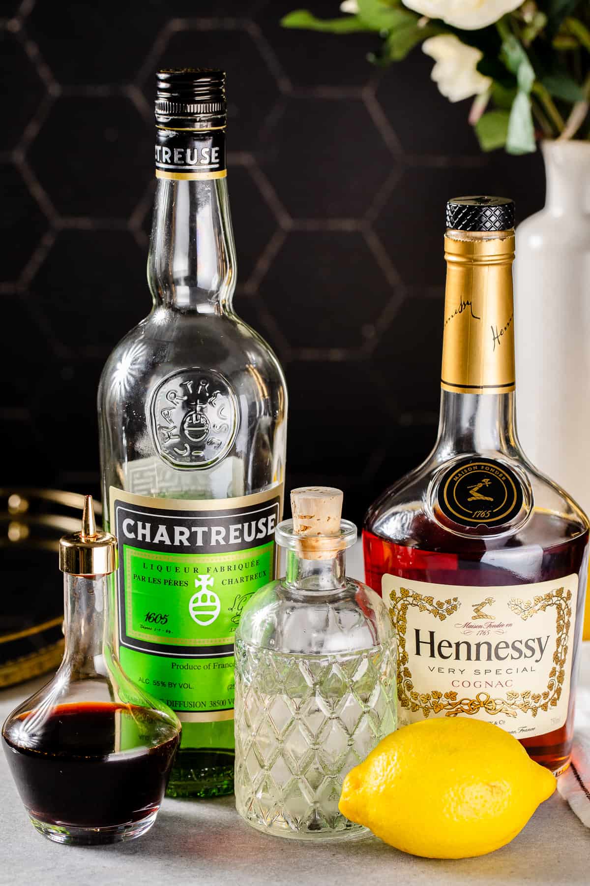 Ingredients needed to make a Champs-Élysées cocktail all together on a tabletop.