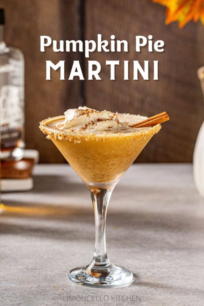 Pumpkin Martini in a martini cocktail glass with a whipped cream and cinnamon stick garnish. In the background is maple syrup. Above the drink is white text saying "Pumpkin Pie Martini".