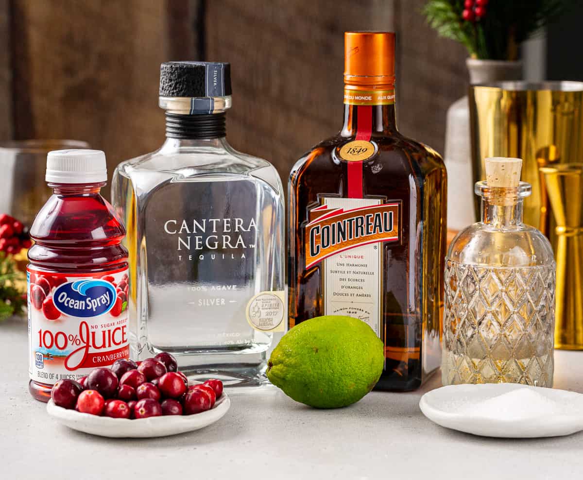 Ingredients for a Cranberry Margarita together on a countertop.