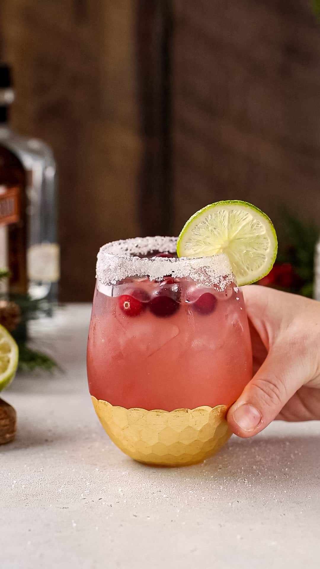 Hand about to pick up a Cranberry Margarita.