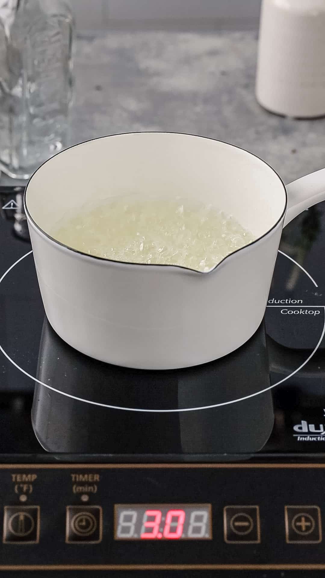 Liquid in a white pot boiling.