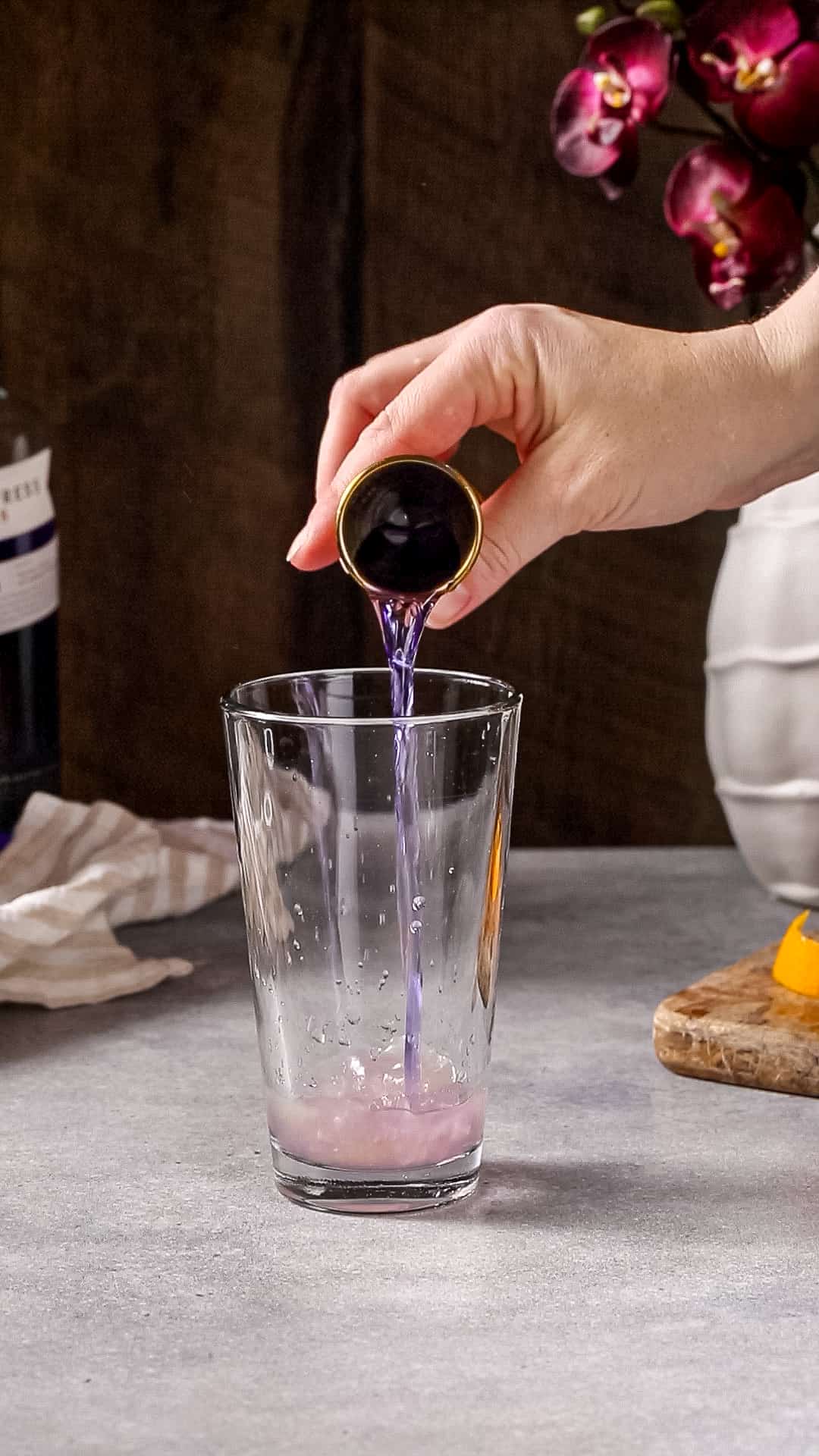 Gin being added to the cocktail shaker glass.