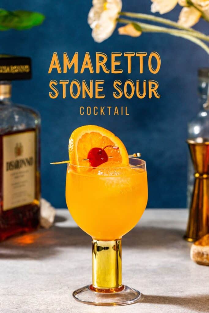 Amaretto stone sour cocktail garnished with an orange and a cherry.