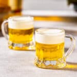 Two little beer shots sitting side by side.