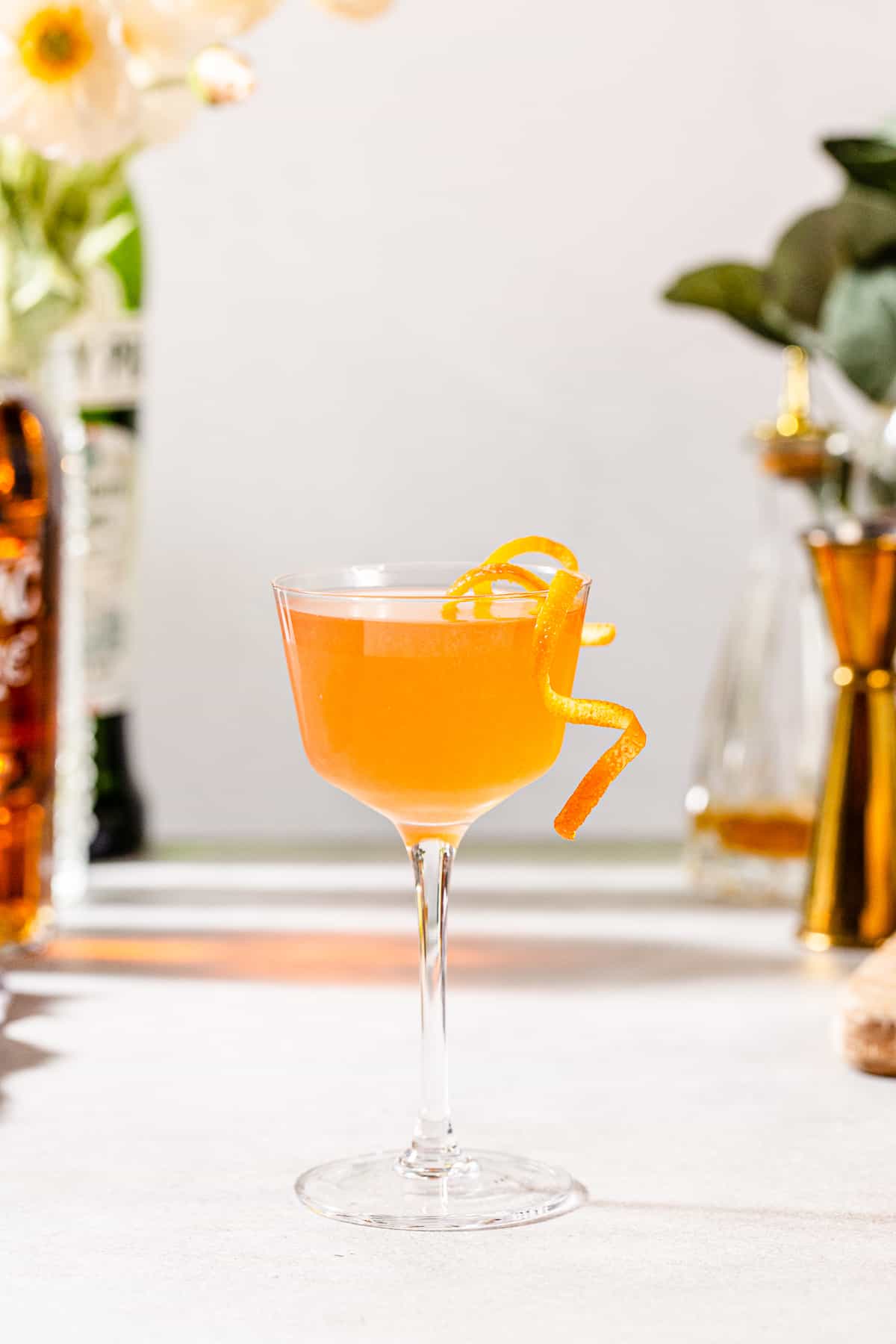 scofflaw cocktail ready to serve with orange garnish.