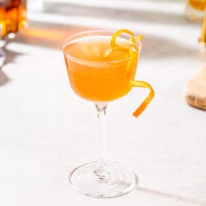 scofflaw cocktail ready to serve with orange garnish.