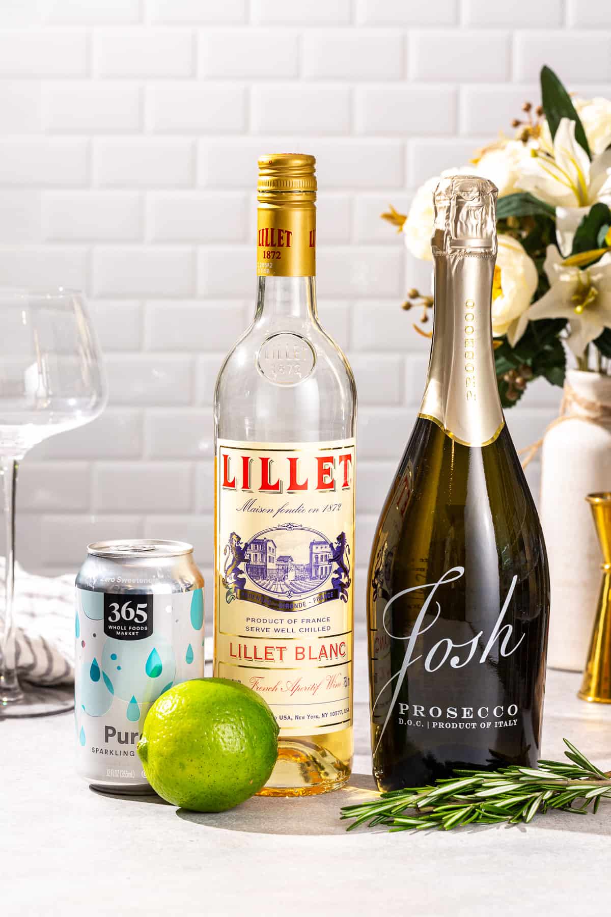 Ingredients to make a Lillet Spritz together on a countertop.