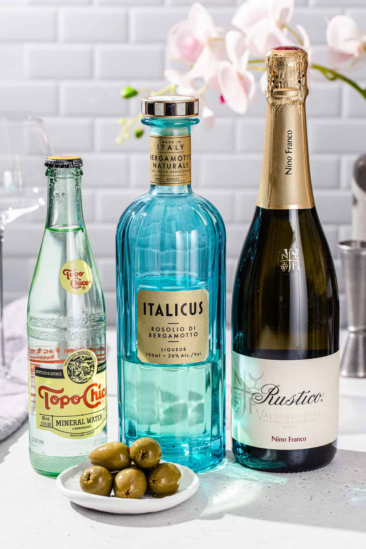 Ingredients to make an Italicus Spritz together on a countertop.