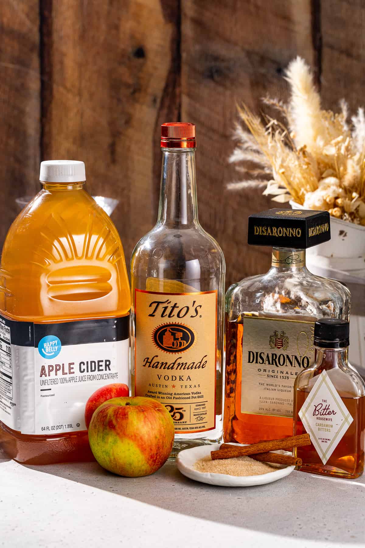 Ingredients to make an Apple Cider Martini together on a countertop.
