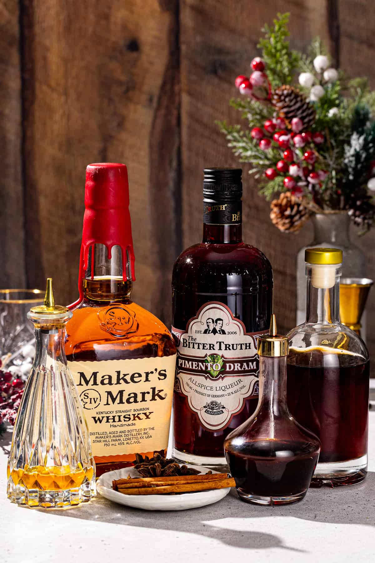 Ingredients to make a Christmas Old Fashioned together on a countertop.