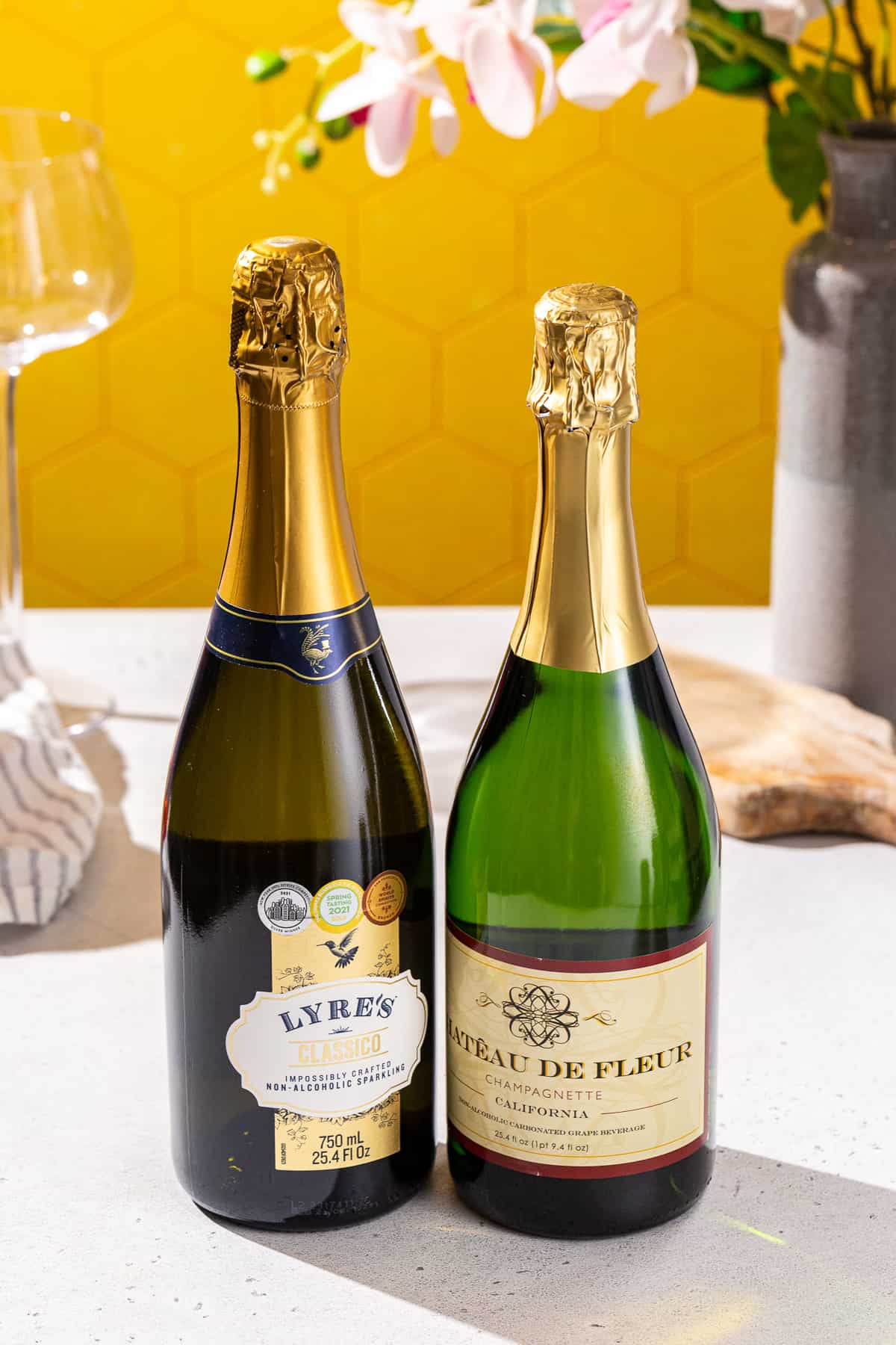 Two bottles of non-alcoholic sparkling wine made by different brands.