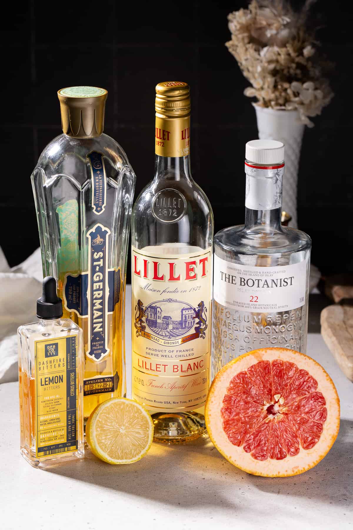 Ingredients to make a French Blonde cocktail together on a countertop.