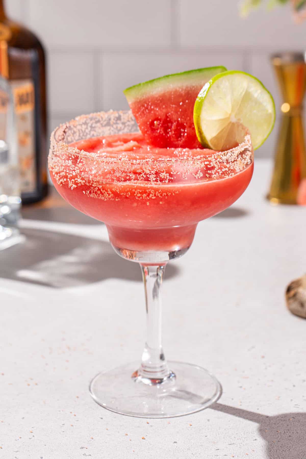 Close up of a Frozen Watermelon Margarita in a margarita glass.